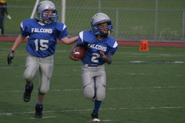 Terrance Crain rushes for a first down with Kole Nelson trailing as a blocker.  After a record season of wins