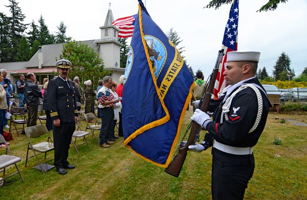 A Naval Air Station Whidbey Island honor guard presents the colors during a Memorial Day service at the Clinton Cemetery on Monday.