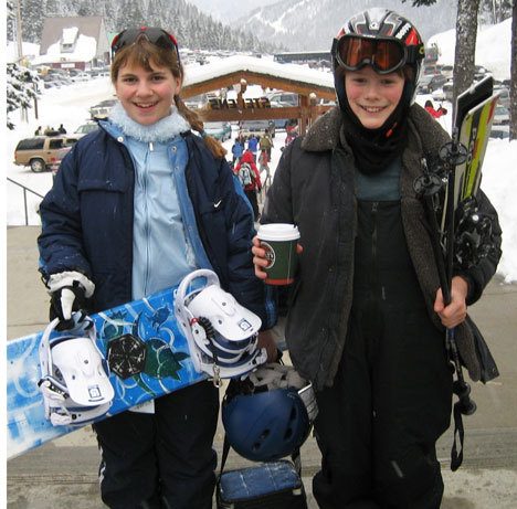 Katie Ewing and Mitch Worthy enjoy some hot cocoa on their way for a day of snowboarding at Stevens Pass