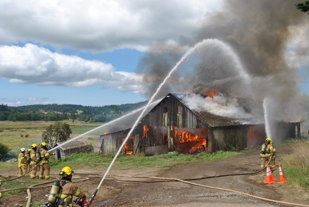 South Whidbey Fire/EMS volunteers take advantage of an old building to practice their water spraying skills.
