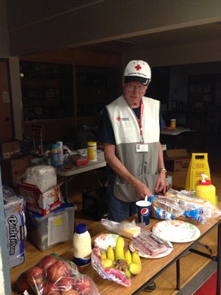 Bob Marcus puts out food for temporary residents at the Mt. Vernon Red Cross shelter. Many of the shelter residents went to work early in the morning and were able to take sandwiches.
