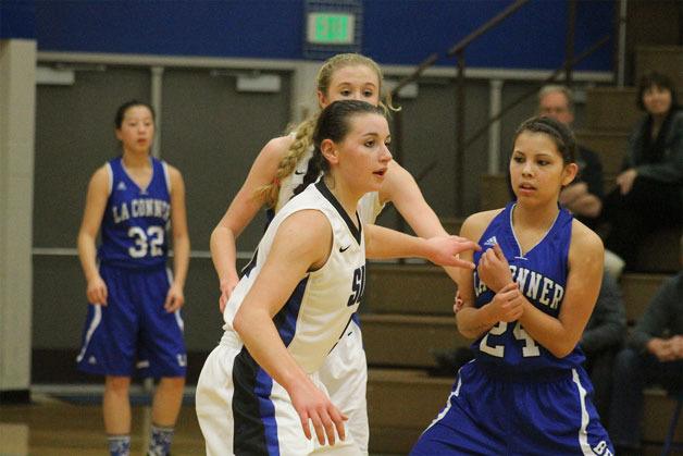 Falcon junior Kacie Hanson readies herself for a Braves offensive attack during South Whidbey’s girls basketball game against La Conner on Dec. 21.