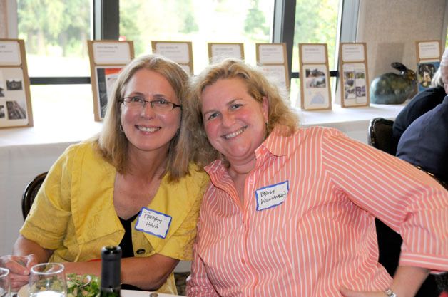 Peggy Hain and Kelly Williamson enjoy the WAIF auction that raised $92