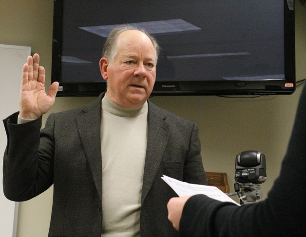Frank Mestemacher swears in as a commissioner for South Whidbey Fire/EMS at the district’s Jan. 14 meeting.