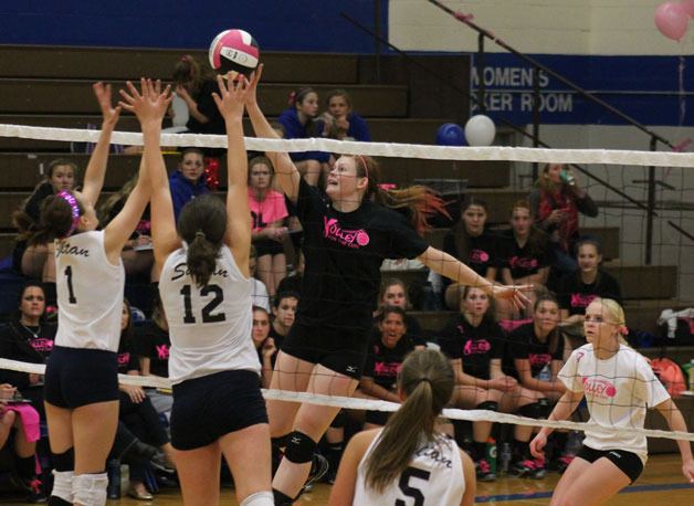 Falcon junior Anne Madsen tips over Sultan’s Devyn Jordan and Claudia Hubbard in the third set Tuesday night.