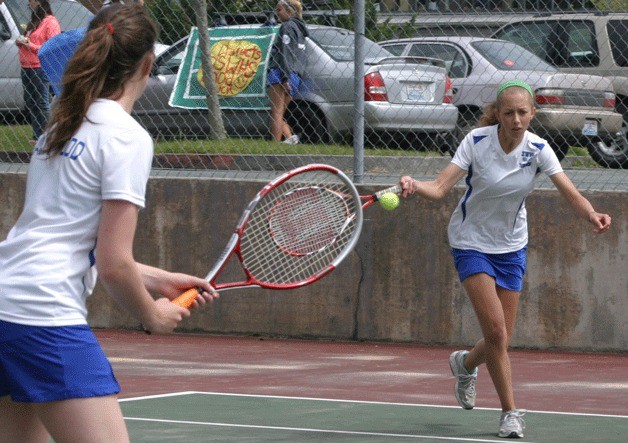 Isla Dubendorf returns a serve in the first round of the 1A District 1 girls tennis tournament. Her partner