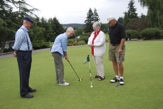 Getting tuned up for the 16th annual Senior Golf Classic on Sept. 15 is Pam Bickel while Ferrell  Fleming