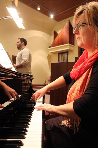 Sheila Weidendorf plays the piano while Mathew Habib sings during a rehearsal for their upcoming concert “‘Twas in the Moon of Wintertime” on Friday