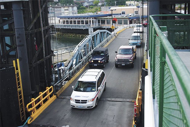 Travelers board the ferry at the Mukilteo dock this week. Officials from Washington State Ferries say state ferries will be busiest during westbound trips on Thursday and Friday