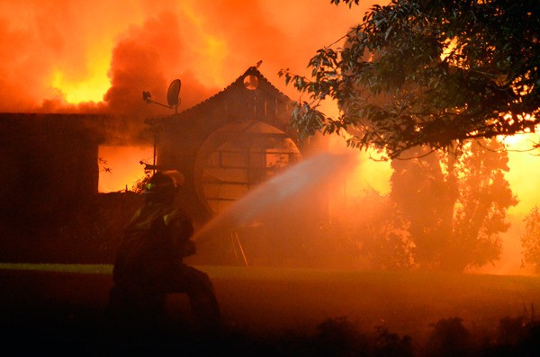 South Whidbey Fire/EMS firefighter Sean Cummins battle a house fire on Myrtle Avenue Saturday evening.