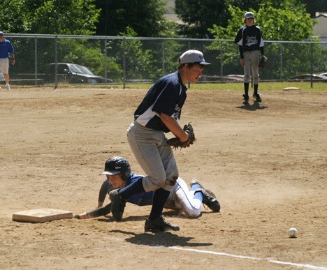 South Whidbey All Star player Colton Sterba slides back into first when the Central Whidbey pitcher tried to tag him out. The 13/14 South Whidbey boys lost their first game 14-4 on Monday.