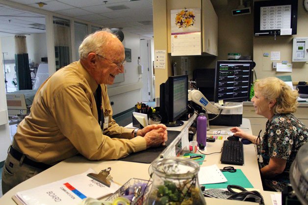 Whidbey General Hospital chaplain Dave Engle chats with Kathryn Clay
