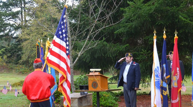 Jim Knott salutes the flag during the 2013 Veterans Day memorial at Bayview Cemetery.