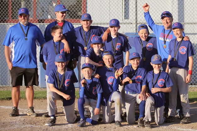 The South Whidbey Little League Cubs celebrate their championship medals from the Andrade Tournament in Oak Harbor over the weekend.
