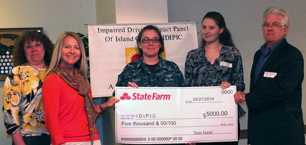 State Farm Insurance representatives Karmin Landry and Tracy Dietz from Karmin’s State Farm agency present a check of $5