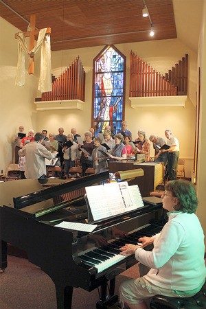 Bill Humphreys leads the choir at Langley United Methodist Church during a recent rehearsal. It was one of his last