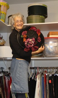 Mira Steinbrecher shows off one of the many hats in the WICA costume shop.