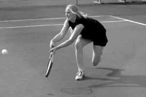 Falcon tennis star Lindsey Newman reaches hard to return a serve from Lynden’s Erica Bosman during Thursday’s rematch of last year’s state  championship. Newman won 6-2