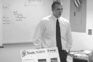 Darrin Britton explains the fine points of the football camp he organized and ran for his senior culminating project.