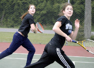 Nicole Zalewski and Victoria Comfort follow the ball over their shoulders in a doubles match Wednesday against Bellingham.