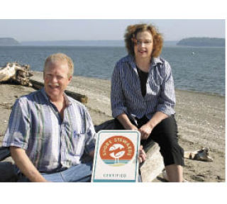 Port of South Whidbey manager Ed Field and Port Commissioner Lynae Slinden savor a perfect spring morning at Clinton Beach while scoping locations for the port’s new Shore Stewards sign.