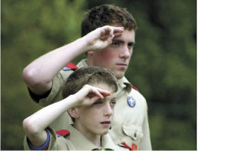 Will Holbert and Michael Scullin salute as the flag is lowered to half-staff during the memorial day cememony at Bayview Cemetery.