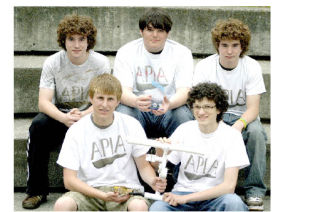The South Whidbey High School builders of the remotely operated submersible vehicle that won second place in the Northwest ROV challenge show off their trophy. In the front row is Kip Hacking and Geoff Wilson; at top are Aren Mattens