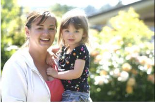 New South Whidbey High School volleyball coach Mandy Jones takes a break with her daughter Grace
