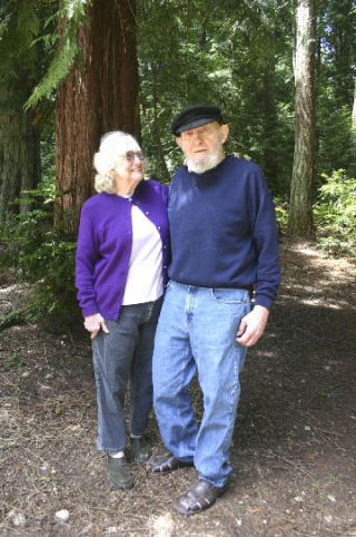 Mary and J T Lowe enjoy a bit of shade at their Langley home that houses two art studios for each them.