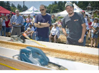 Winner Chris Ceci (left) watches as his machine outraces that of Mike Shorey (right) to win the annual belt-sander races in Freeland on Friday. It was Ceci’s third consecutive championship.
