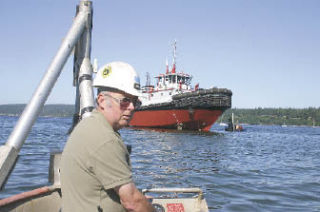 Yard foreman and launch supervisor Ken Gillette checks conditions as he awaits high tide.