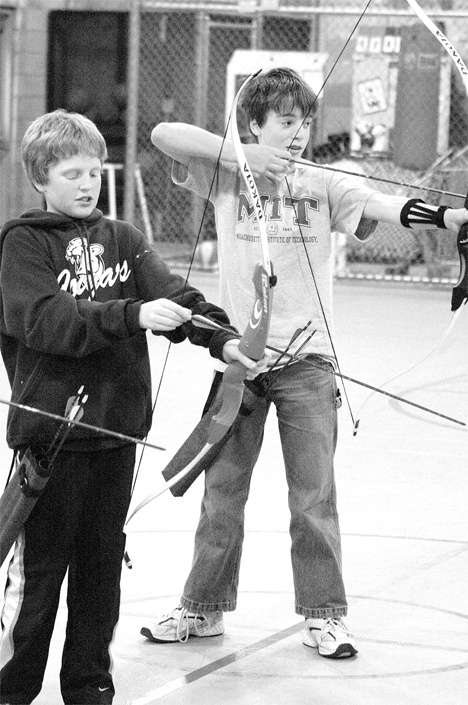 Max Corell and Kellen Field test their archery skills Wednesday in the gym at Langley Middle School. The two are part of a South Whidbey Parks & Recreation District after-school program.