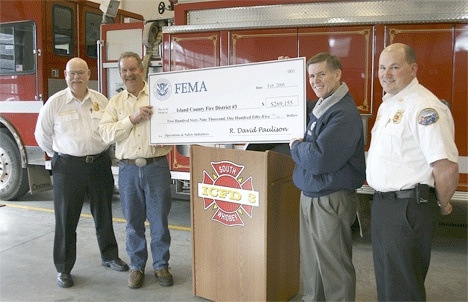 FEMA Deputy Regional Administrator Dennis Hunsinger presents a grant check to Fire District 3 as Chief Dan Stout