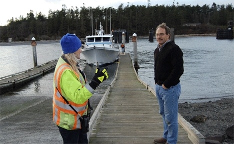 Peter Hanke talks with a ferry worker as his boat
