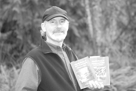 Chris Highland displays the two books he recently completed and self-published