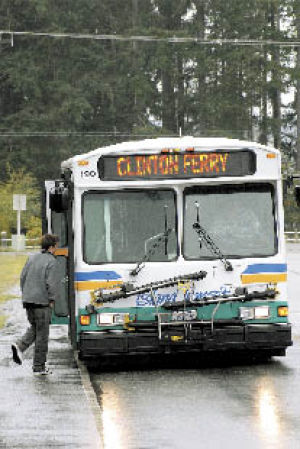 A passenger near Casey’s Red Apple gets set to board an Island Transit bus headed to the  Clinton ferry terminal on Friday.