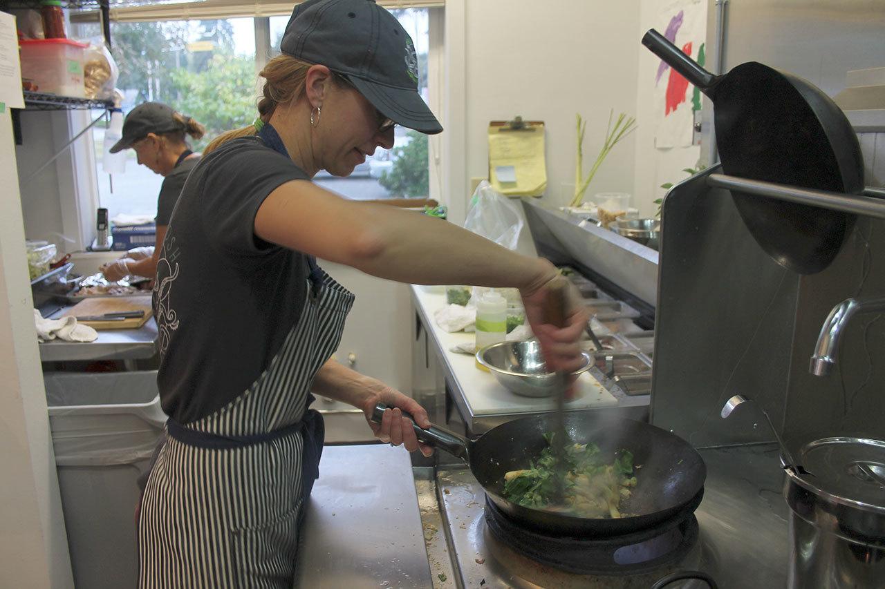 Co-owner Stephanie Pendell quickly whips up noodles in a wok.