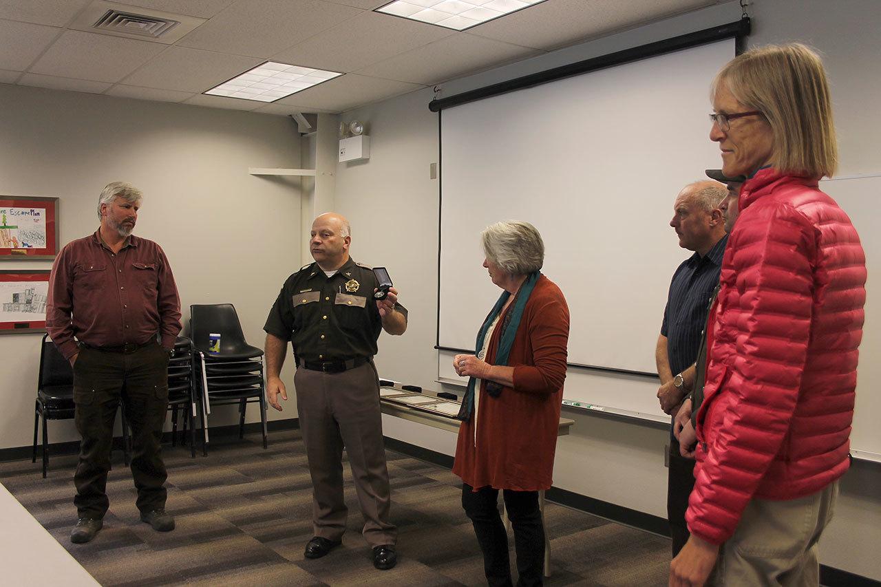 Chief Criminal Deputy Rick Felici recognizes the Greenbank residents who helped save a young man’s life after a chainsaw accident caused severe injuries. From left to right: Tony Hartman, Felici, Linda Riley, Chris Chan and Kate Stegemoeller.