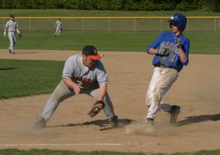 Falcon Mick Poynter makes it back to first base Friday during South Whidbey’s final game of the season