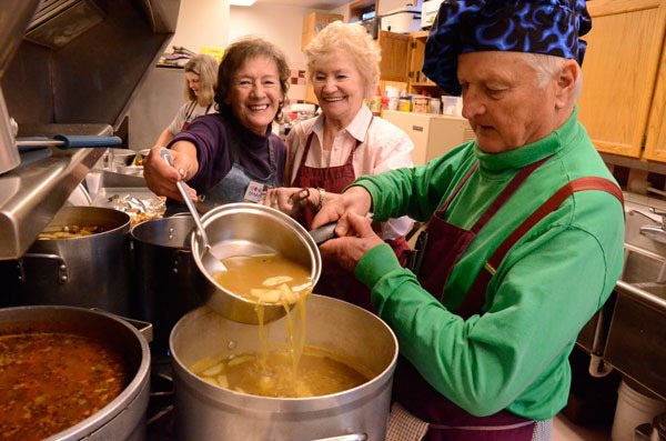 Sharon Giberson and Jean Matheny help Chef Dan Saul mix soup early Tuesday morning in preparation for the day’s lunch. The Soup Kitchen in Langley is expected to serve its 1