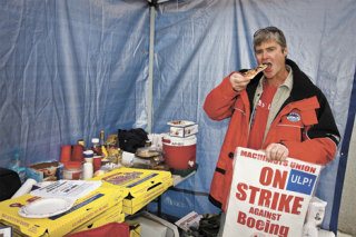 Don Johnson grabs a bite to eat while on strike duty in Everett.