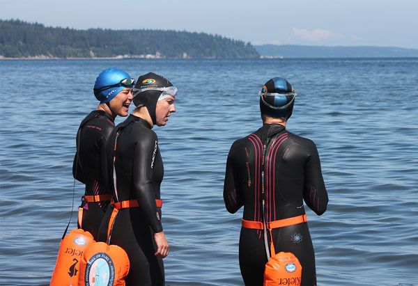 Three of the bold year-round swimmers catch up before taking a plunge in front of Seawall Park in Langley. The ladies are often the ones who rally the troops in less forgiving conditions. From left to right: Megan Scudder