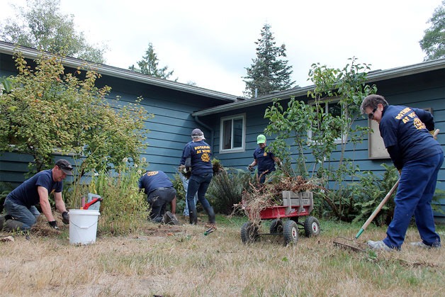 Volunteers with Rotary Club of Whidbey Westside offer a helping hand with some much needed yard work at Whidbey Island Children’s Center.