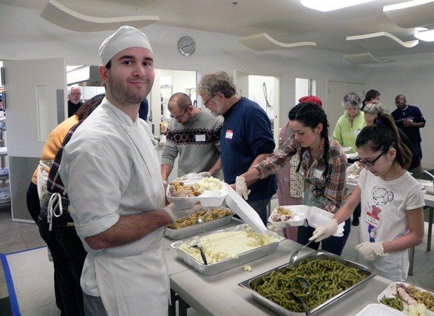 James Canby dishes up during last year’s Mobile Turkey Unit day on Thanksgiving. He started helping as a boy.