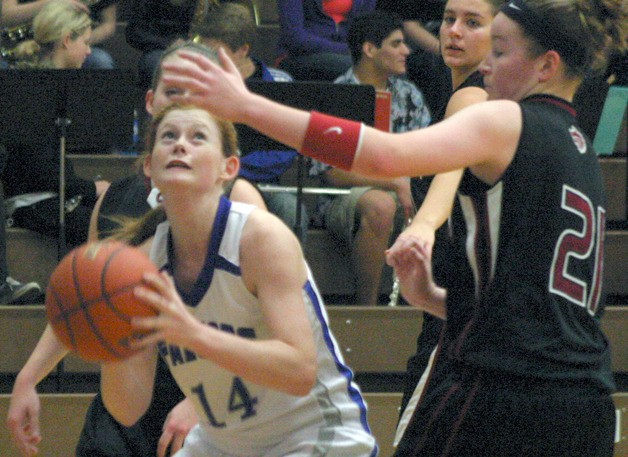 Falcon sophomore Anne Madsen runs into a pair of Red Wolves defenders on Tuesday.