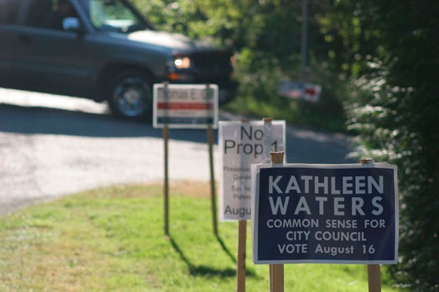 Campaign signs line the roadway on Sandy Point Road.