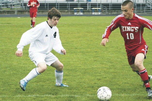 David Woodbury sets to stop King’s senior forward  Ryan Gamache. The Knights won 1-0 with a goal in the 58th minute that ended South Whidbey’s five-game winning streak.