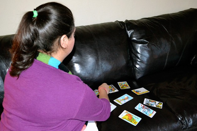 Clinton psychic Stacey Guy deals Tarot cards Tuesday at her office.