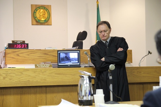 Island County District Judge Bill Hawkins listens to a recording in a hearing prior to hospital administrator Linda Gipson’s trial.