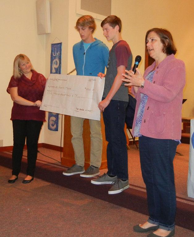 Contributed photos South Whidbey High School students Aengus Dubendorf and Ari Rohan (center) present a $1